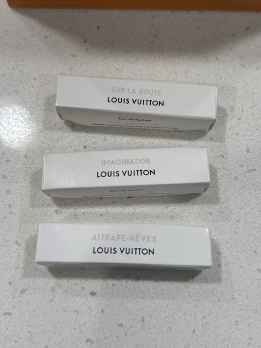 Louis Vuitton perfumes and small shopping bag